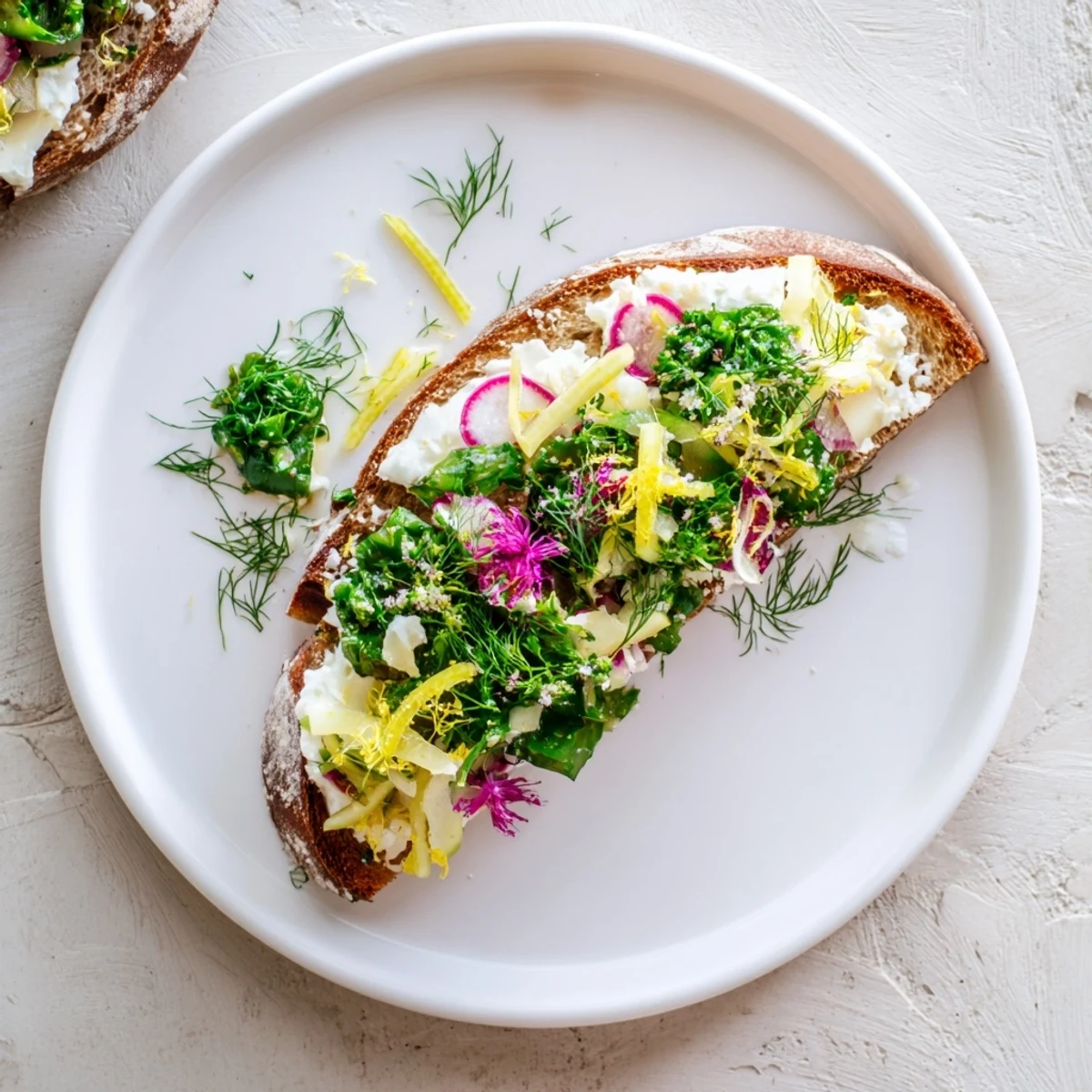 Crisp garden vegetables adorn Fresh Meadow-Inspired Garden Vegetable Tartines with creamy herbed cheese on toasted bread.