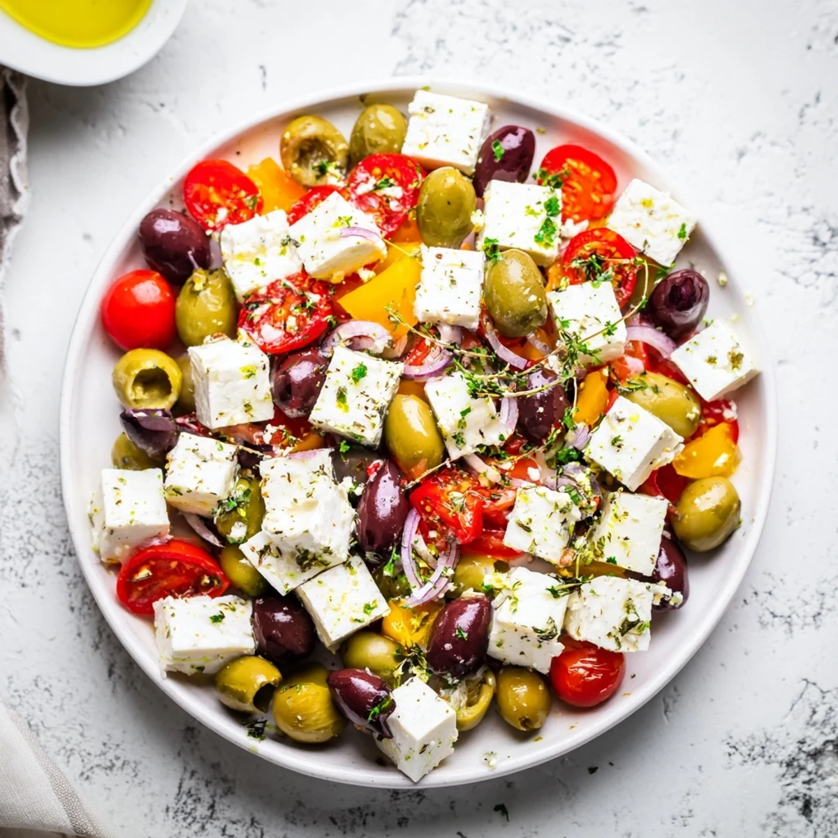 Holiday Mix: Mixed Olives with Feta Cubes, a flavorful appetizer, ready to serve with fresh parsley.