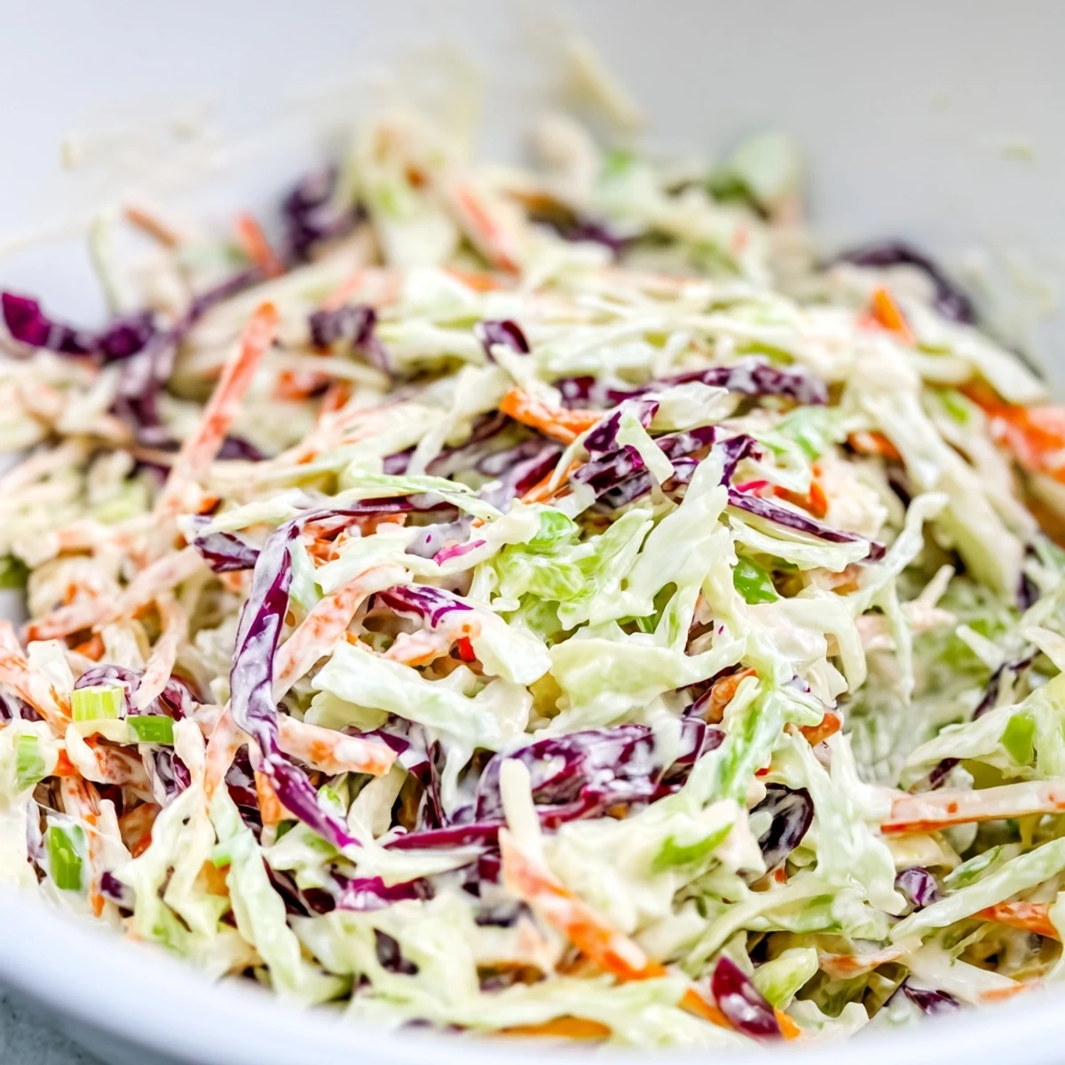 Bright, crunchy Best Cabbage Coleslaw with shredded cabbage and carrots in a creamy dressing, paired alongside grilled chicken.