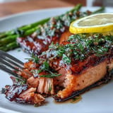 Succulent salmon fillet with zesty lemon and fragrant dill, roasted alongside crisp asparagus for a flavorful one-pan meal.