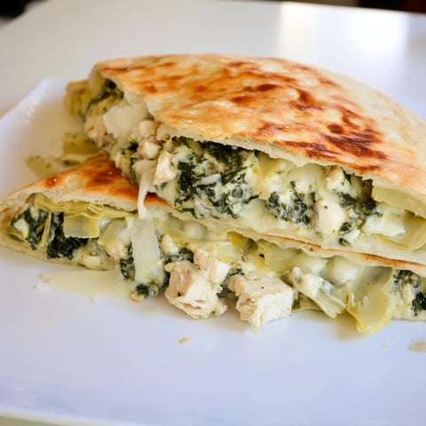 Four golden-brown, stuffed pita pockets filled with creamy spinach artichoke chicken, baked to melted cheese perfection.