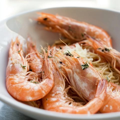 This bowl of Light & Bright Lemon Herb Shrimp Scampi features tender shrimp in a bright, lemony broth.