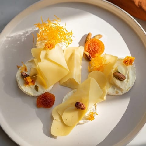 Indulge in The Saffron Silk: This cheese board features luxurious spreads and artfully arranged cheeses with tasty additions.