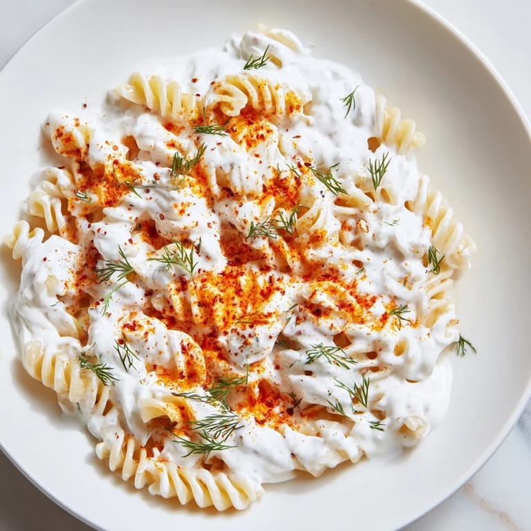 Aromatic bowl of Turkish Yogurt Pasta, with fusilli coated in yogurt and drizzled with sizzling spiced butter.