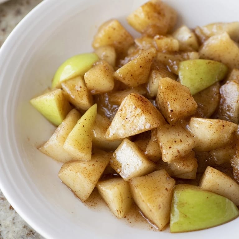 Golden slow cooker stewed apples, a comforting treat, with hints of cinnamon and honey.