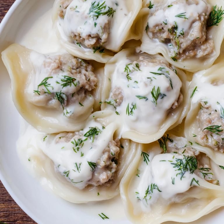 A close-up of savory Russian Pelmeni: perfectly formed meat dumplings, ready to be enjoyed.